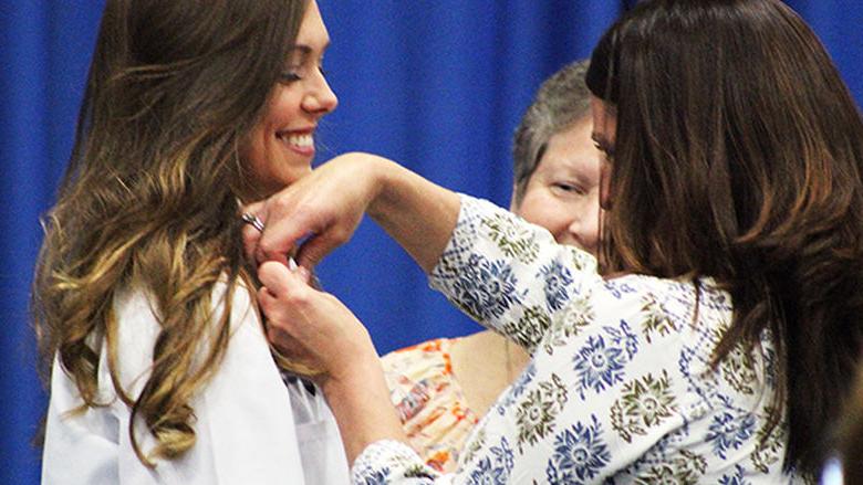 Nursing student Sidney Crain is pinned by a family member.