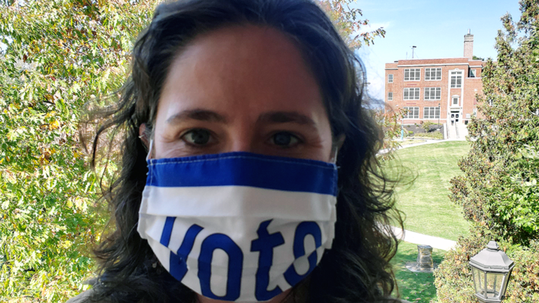 Female professor wearing mask with "Vote" 