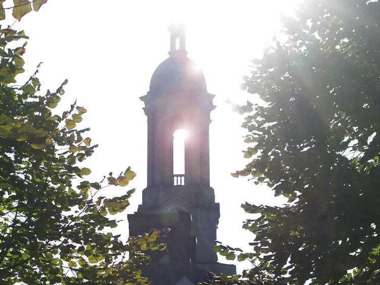 Sun streaming through Penn State's Old Main bell tower